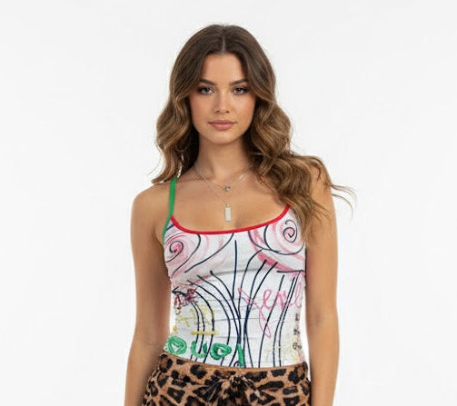 Woman wearing a colorful designer tank top and leopard print shorts on a white background